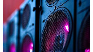 Close-up of a high-fidelity large-scale festival speaker stack with intricate wiring and acoustic panels, symbolizing advanced sound systems.